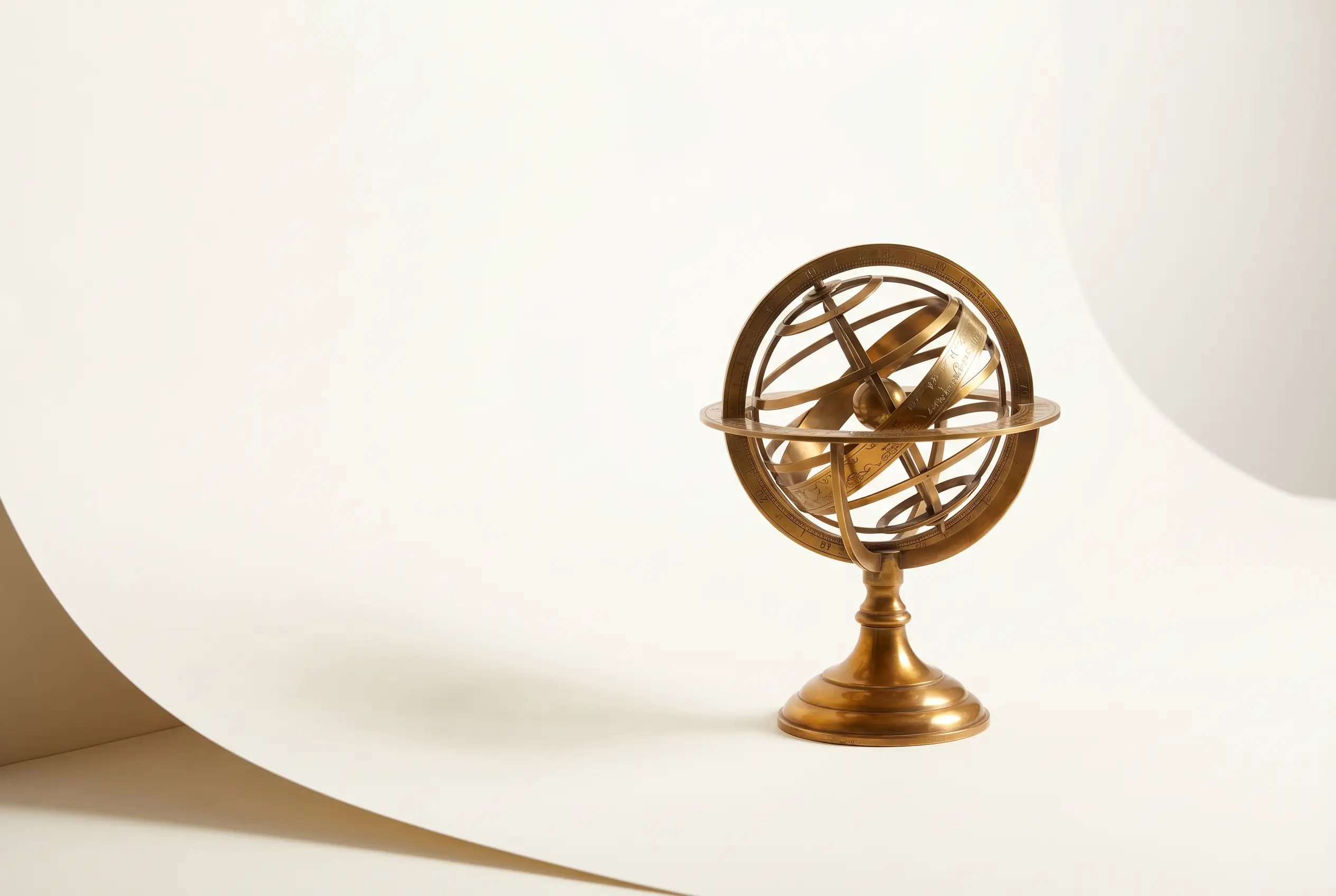 A brass armillary sphere on warm paper
